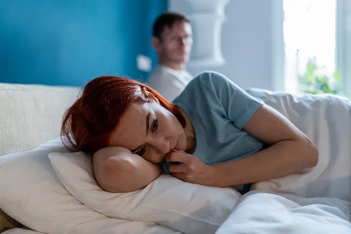 unhappy couple in bed