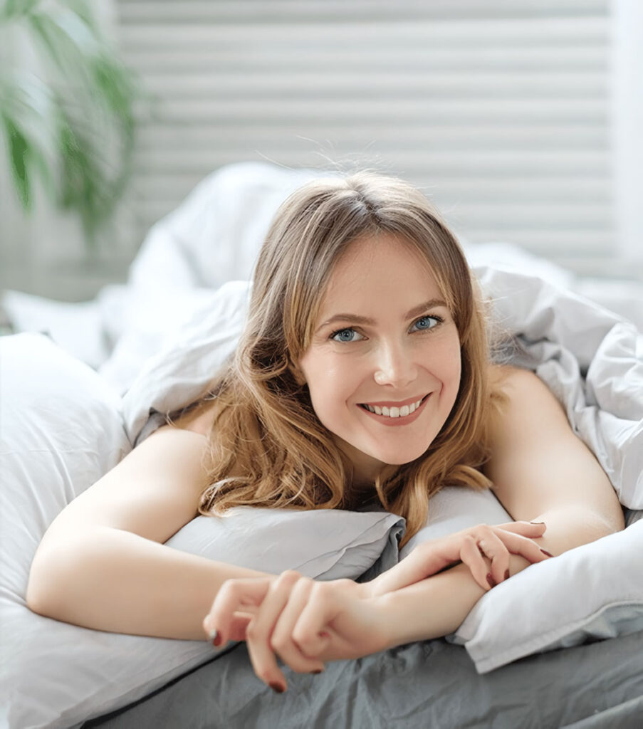 women in bed smiling