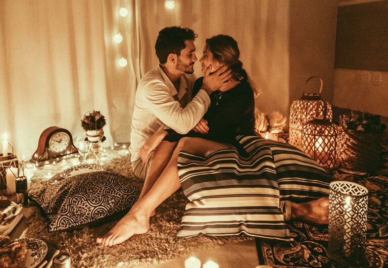 Man and Woman Sitting on the Floor and About to Kiss