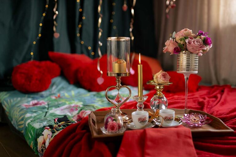 Romantic bedroom setup with flowers and candles
