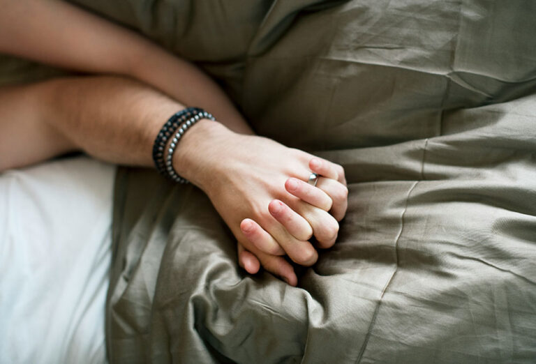 Caucasian couple lying together on a bed