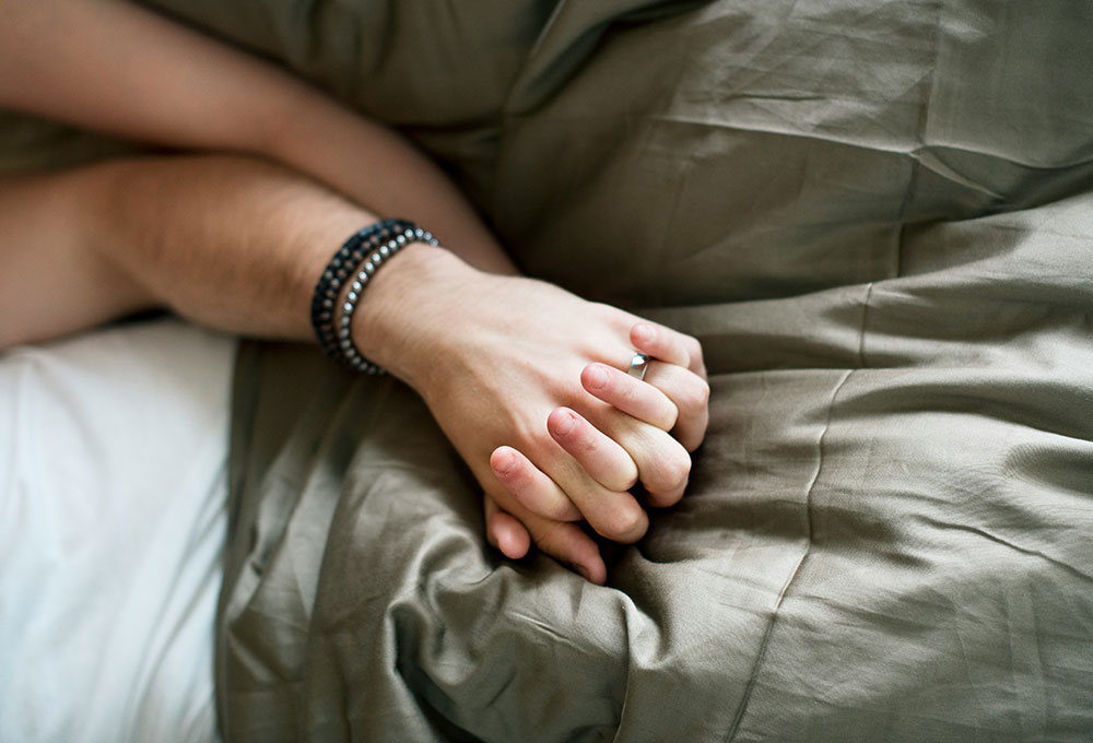 Caucasian couple lying together on a bed
